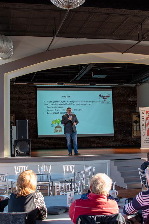 JJ speaking in front of a group